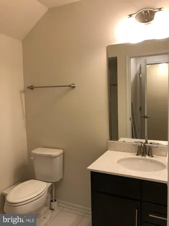 a bathroom with a sink a toilet a mirror and shower