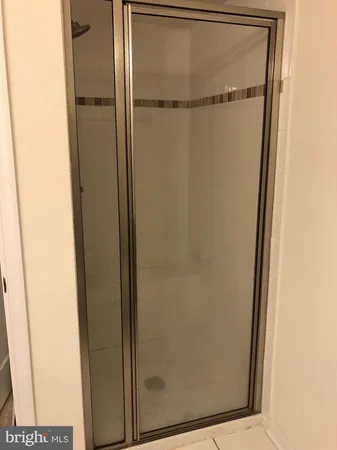 a bathroom with a glass shower door