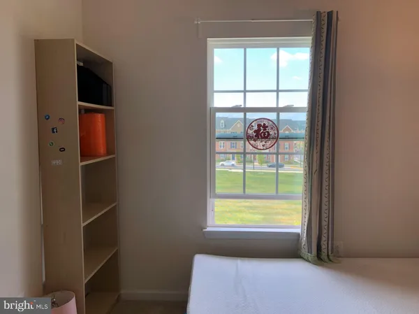 a view of room with window and front door