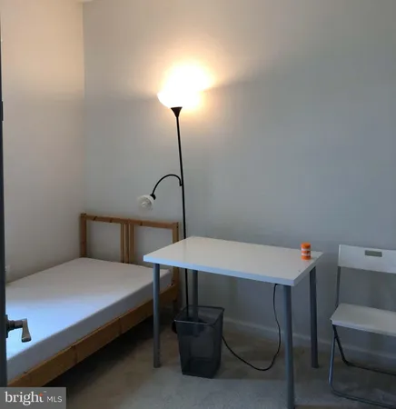 a bedroom with a bed and a table