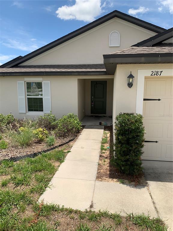 2187 Mandarin Loop Dundee, FL 33838 - Photo 4 of 11 a front view of a house with garden