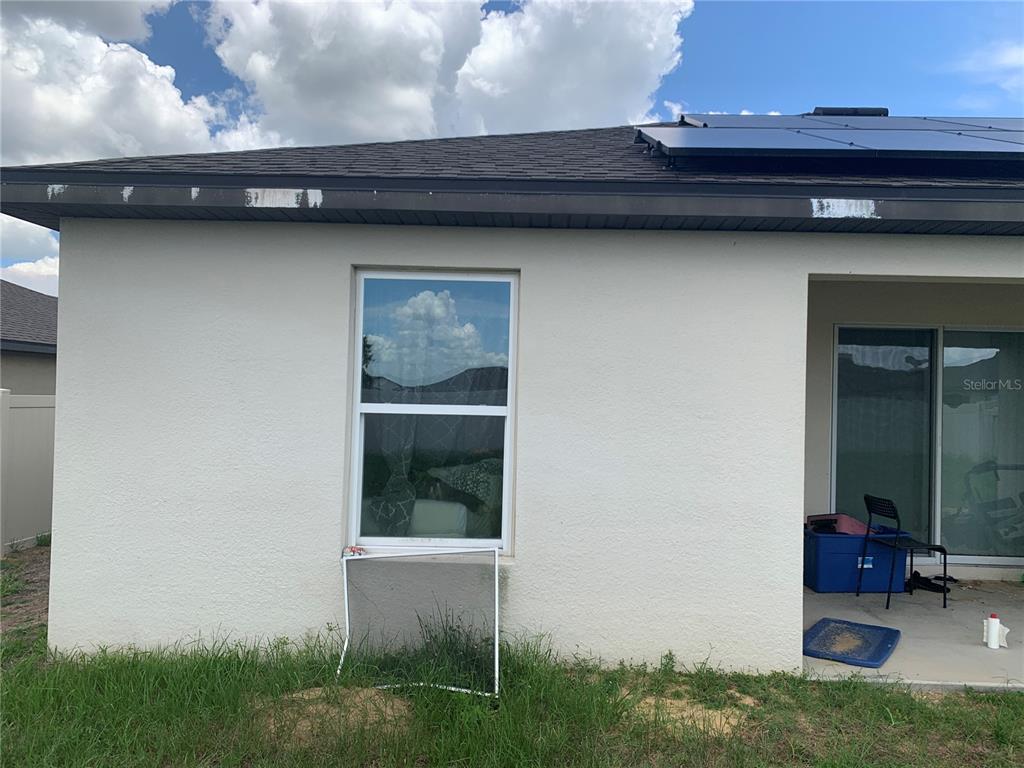 2187 Mandarin Loop Dundee, FL 33838 - Photo 5 of 11 a view of a backyard with a barbeque grill and plants