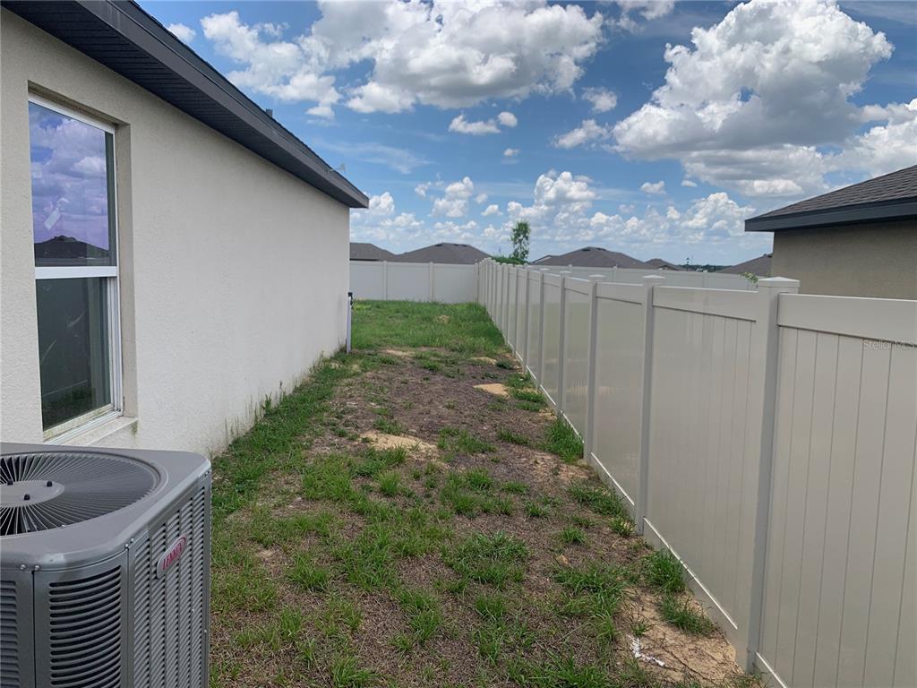 2187 Mandarin Loop Dundee, FL 33838 - Photo 8 of 11 a backyard of a house with lots of green space