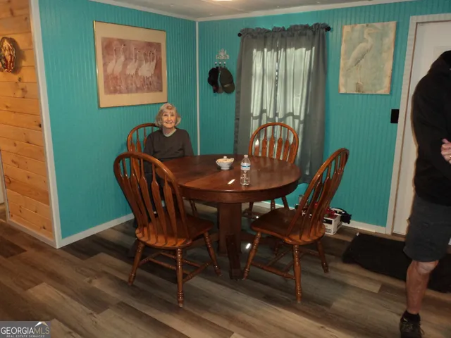 a view of a yard with wooden fence