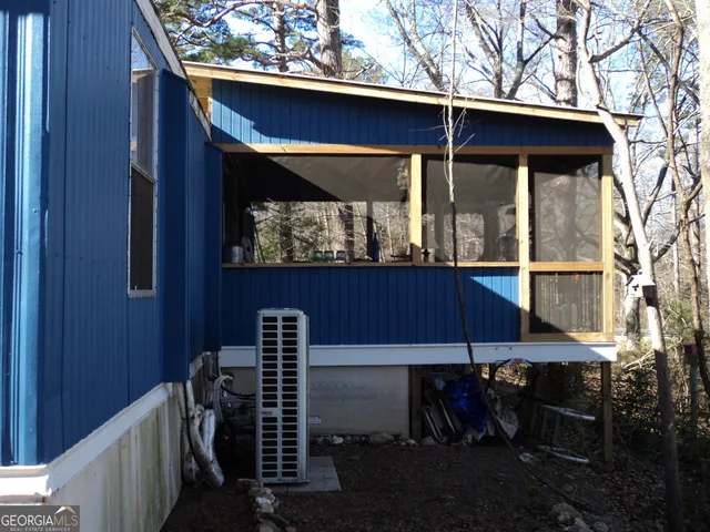 a view of a porch with wooden floor and outdoor seating