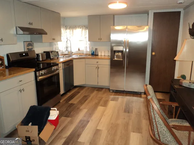 a kitchen with a sink stove and refrigerator