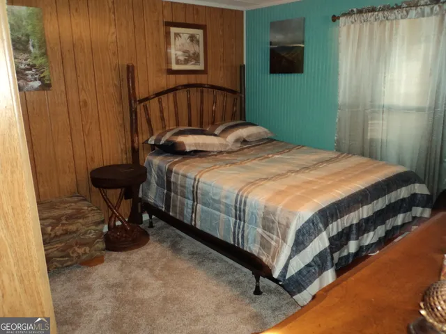 a bedroom with a bed and a table in it