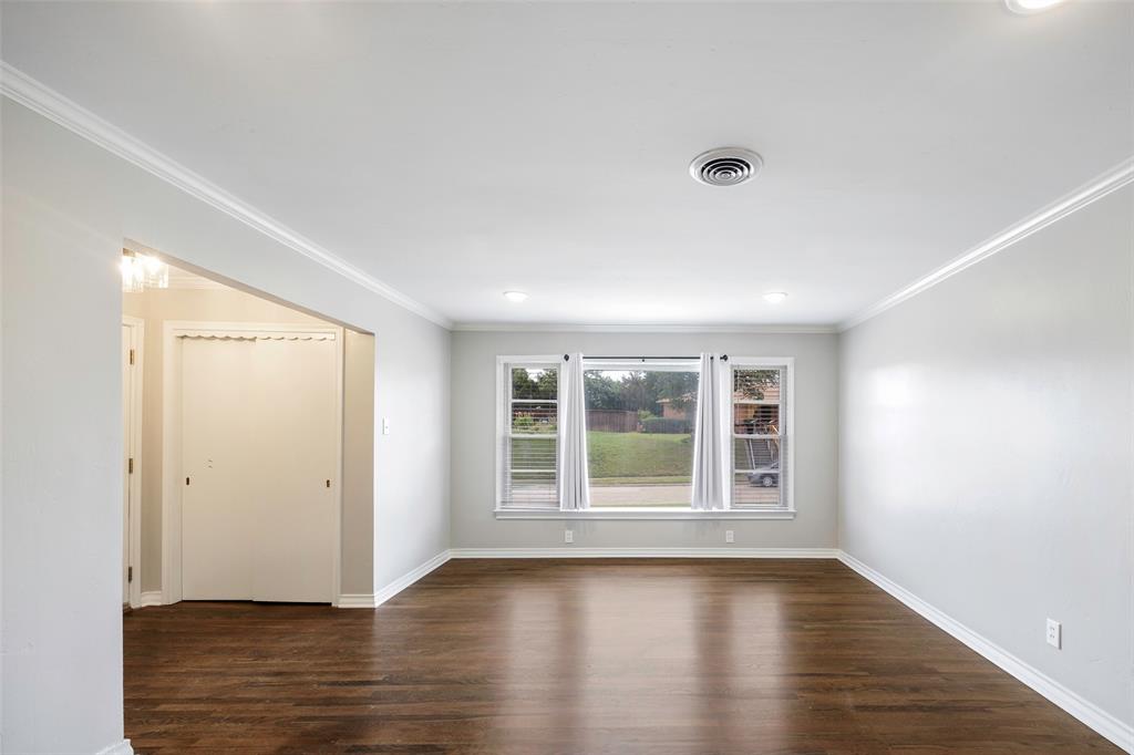 2323 Sutter Street Dallas, TX 75216 - Photo 6 of 30 Empty room featuring dark hardwood / wood-style floors and ornamental molding