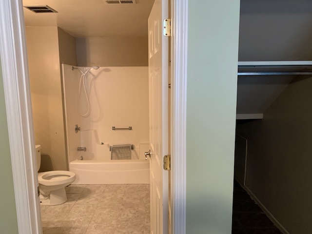 304 Thistle Drive Bolingbrook, IL 60490 - Photo 7 of 9 a bathroom with a granite countertop bathtub shower and toilet