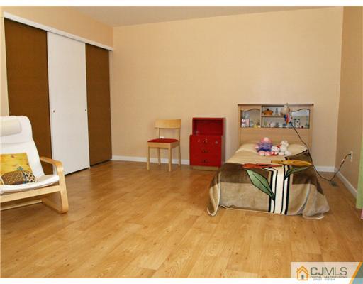 5605 Hana Road Edison, NJ 08817 - Photo 12 of 23 a workspace with furniture and wooden floor