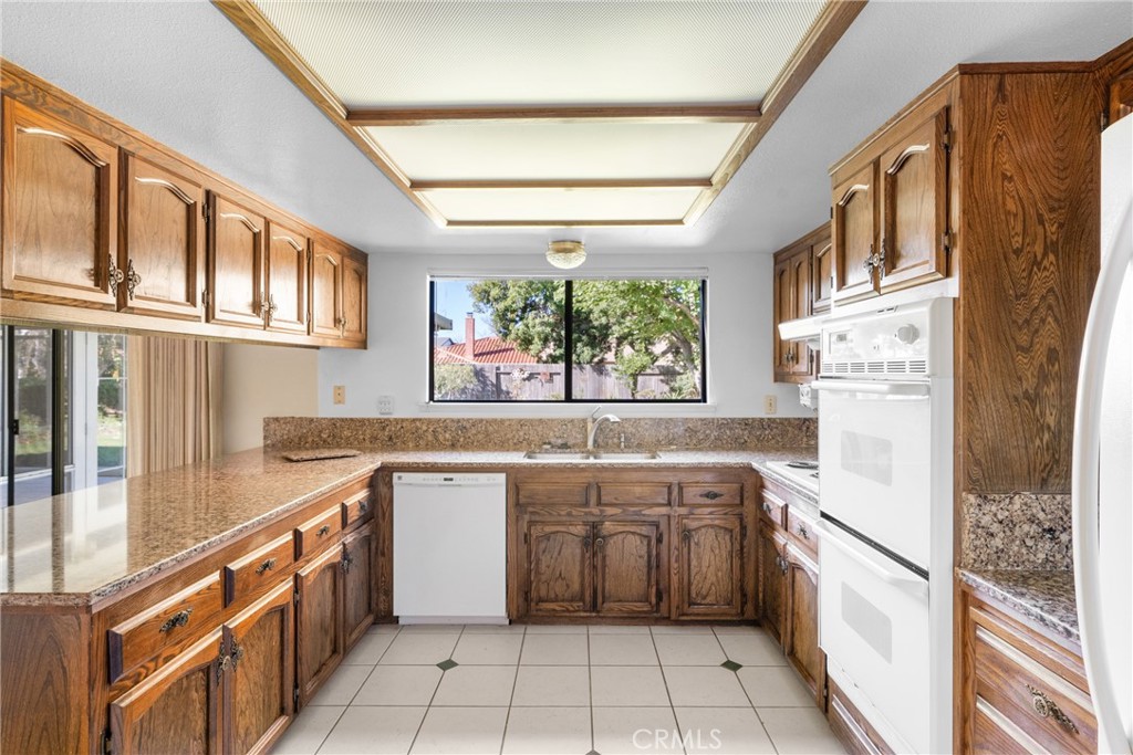 4347 Manchester Court Santa Maria, CA 93455 - Photo 16 of 40 a kitchen with stainless steel appliances granite countertop a refrigerator and a sink