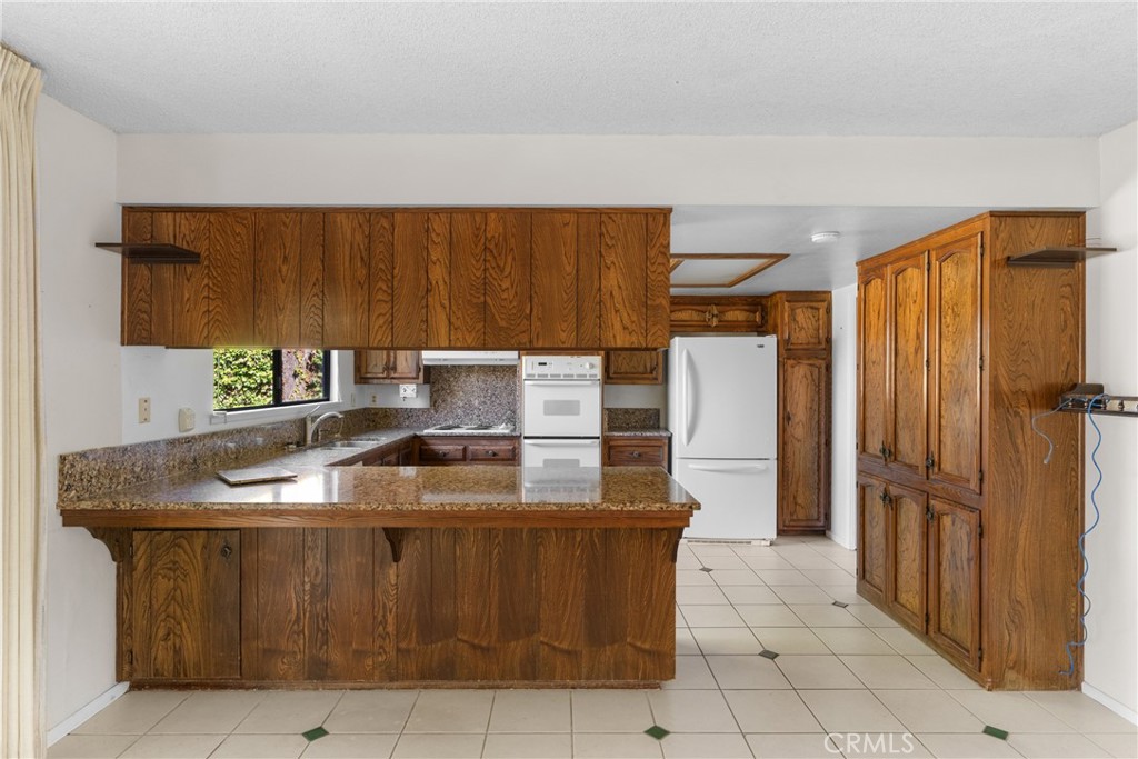 4347 Manchester Court Santa Maria, CA 93455 - Photo 19 of 40 a kitchen with stainless steel appliances granite countertop a sink stove and refrigerator