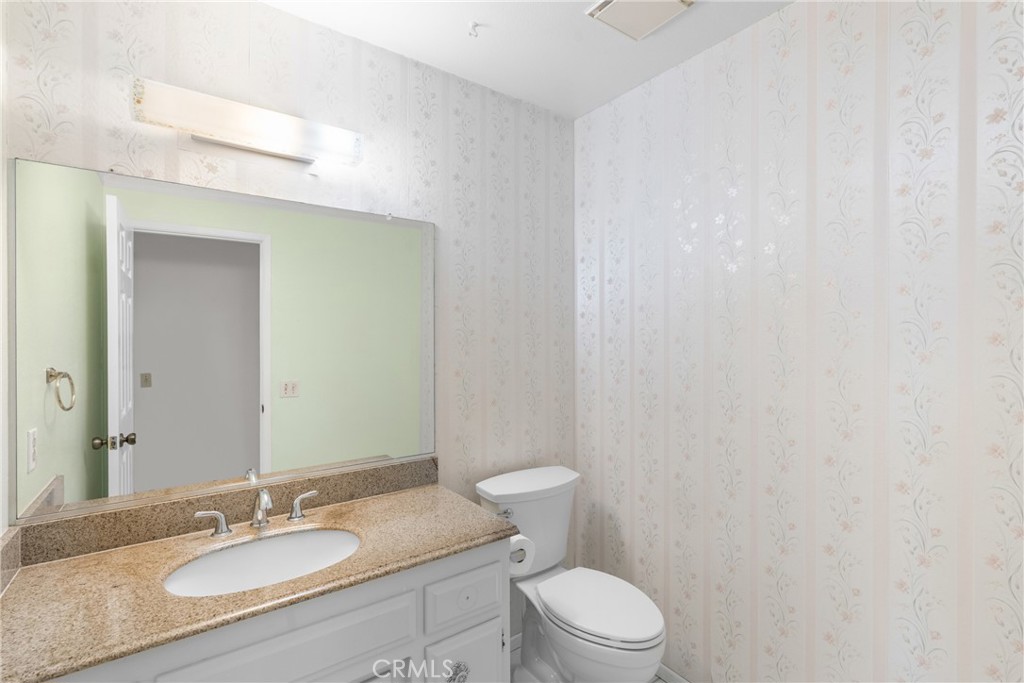 4347 Manchester Court Santa Maria, CA 93455 - Photo 30 of 40 a bathroom with a granite countertop sink toilet and a mirror