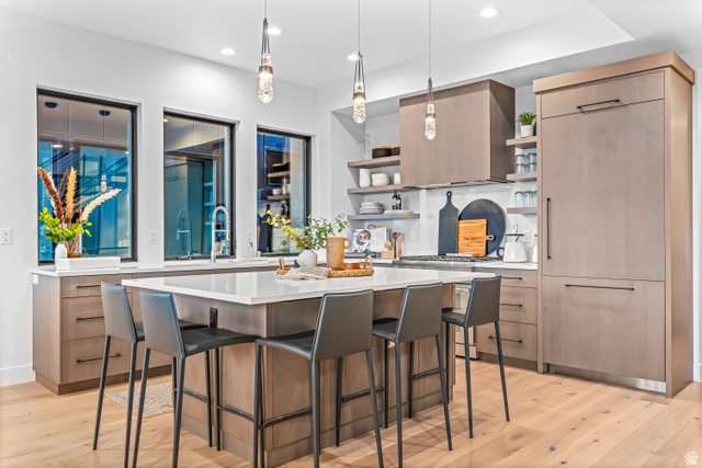 1258 Rothwell Road Park City, UT 84060 - Photo 6 of 48 Kitchen featuring a large central island with seating, integrated appliances, wood-finish cabinetry, and extensive counter space