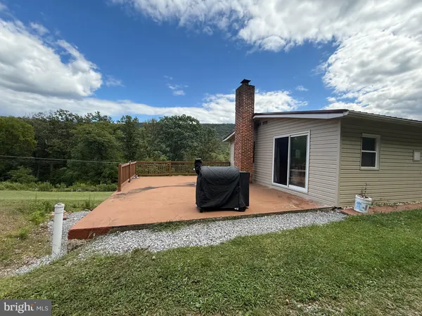 a view of outdoor space with deck and yard