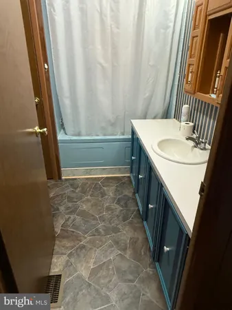 a view of an empty room with window and closet