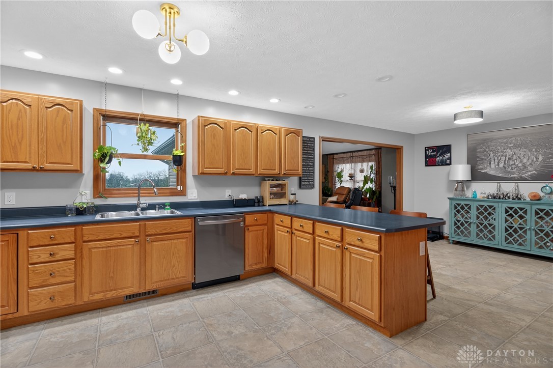 5264 Frazier-Guy Road Sidney, OH 45365 - Photo 15 of 51 This spacious kitchen offers ample cabinetry and counter space, ideal for culinary pursuits.