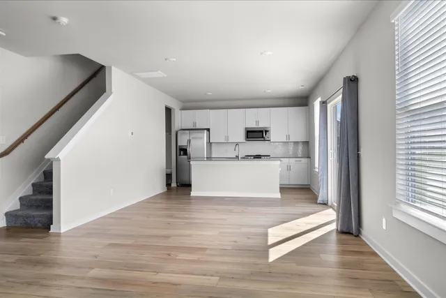 a view of kitchen with microwave and cabinets