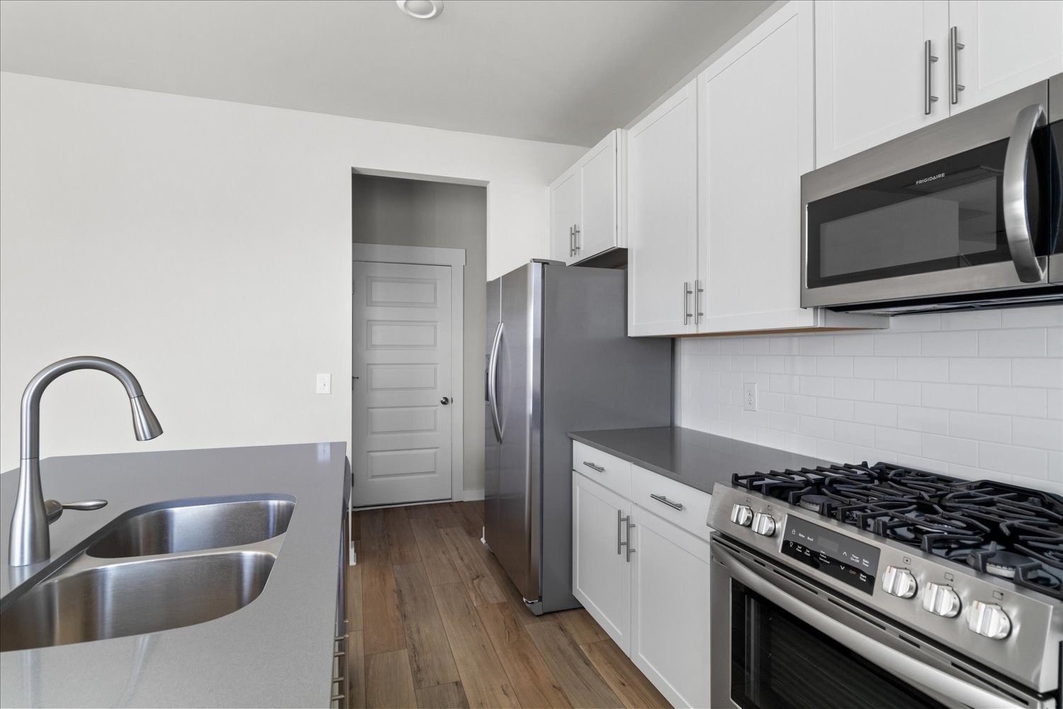910 Sassafras Ct Spring Hill Spring Hill, TN 37174 - Photo 8 of 20 a kitchen with stainless steel appliances a stove a microwave a sink and cabinets
