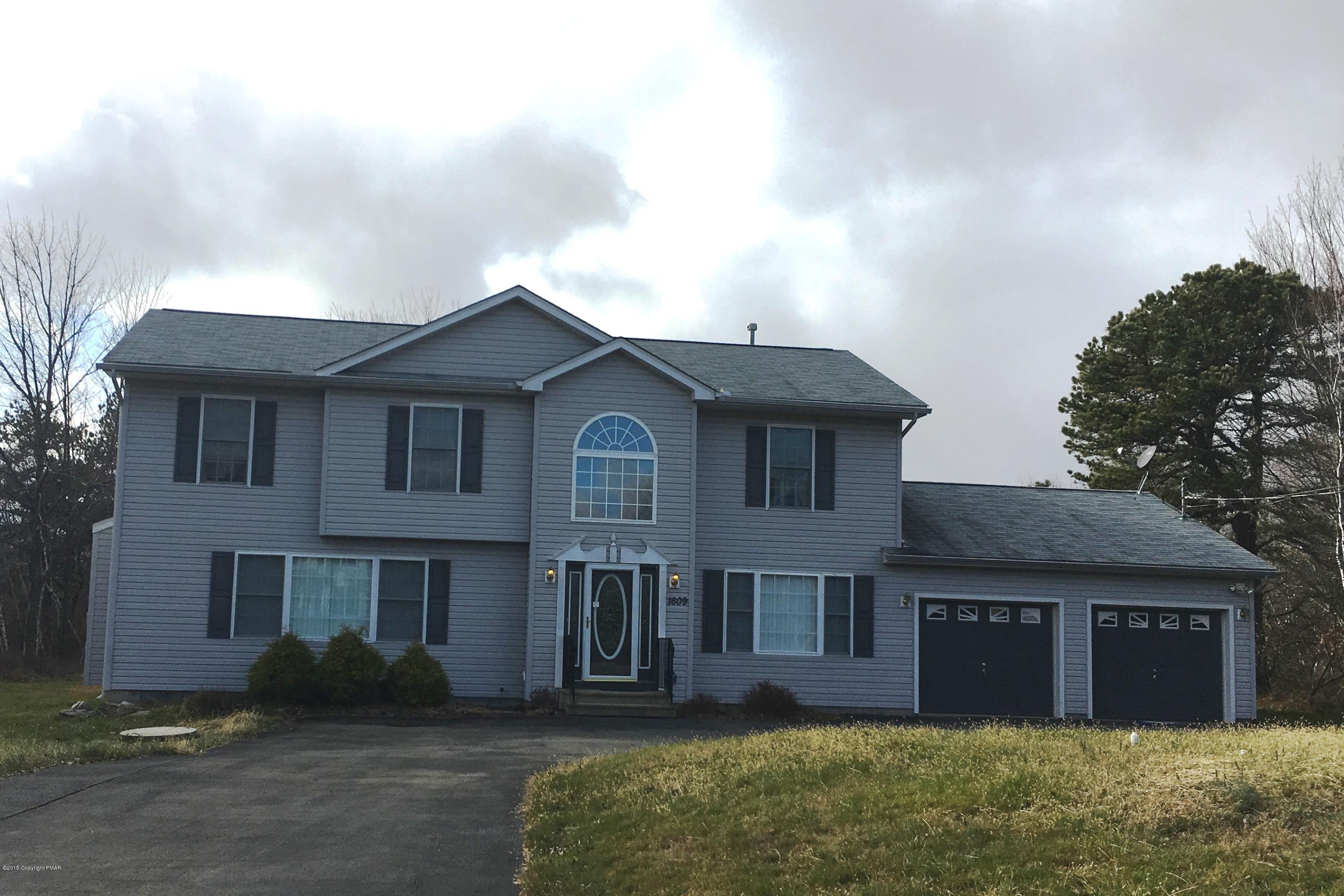 1609 Clover Road North Long Pond, PA 18334 - Photo 1 of 24 a front view of a house with a garden