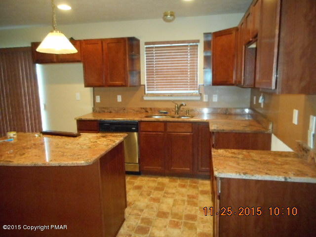 1609 Clover Road North Long Pond, PA 18334 - Photo 8 of 24 a kitchen with stainless steel appliances granite countertop a sink stove and cabinets