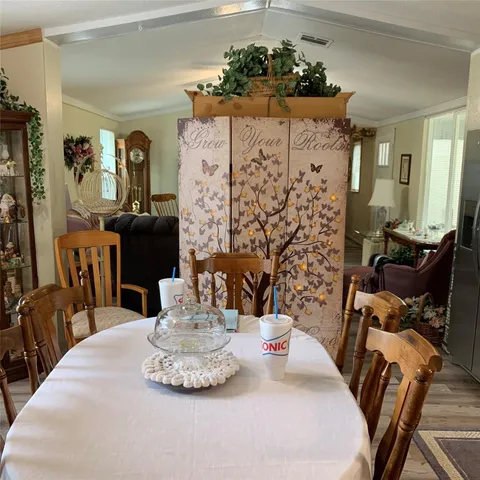 a dining room with furniture and wooden floor