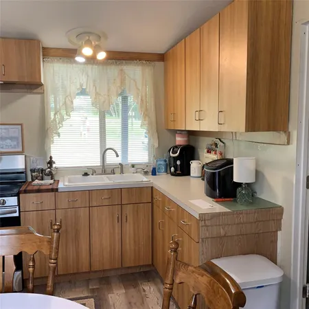 a kitchen with a sink cabinets and window