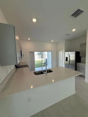 a large white kitchen with a large window