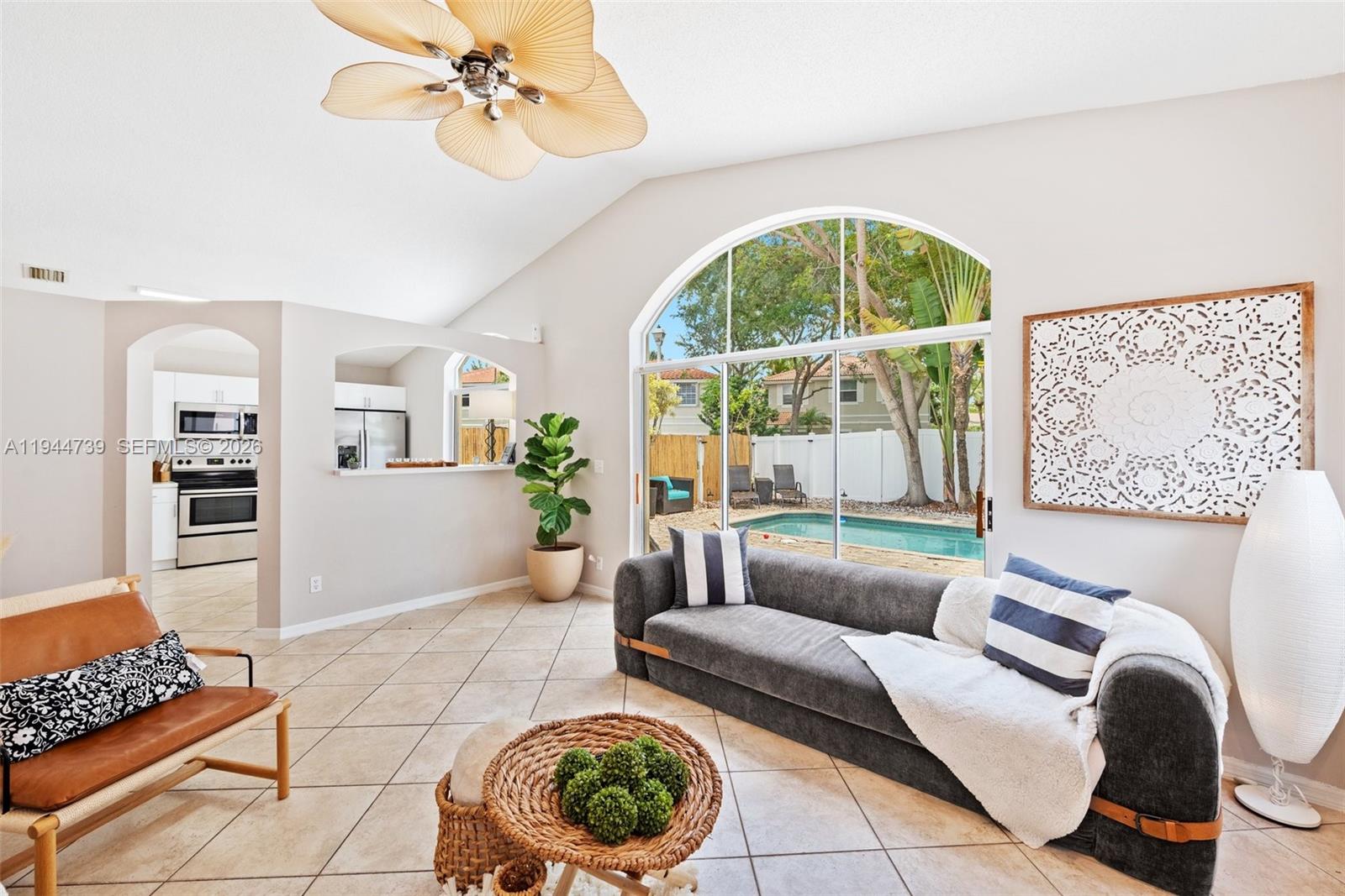 955 Azure Lane Weston, FL 33326 - Photo 12 of 34 a living room with furniture and a floor to ceiling window