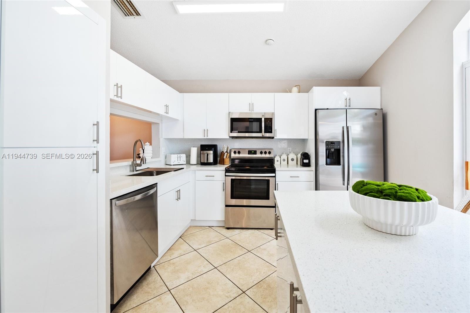 955 Azure Lane Weston, FL 33326 - Photo 15 of 34 a kitchen with stainless steel appliances kitchen island granite countertop a refrigerator sink and stove