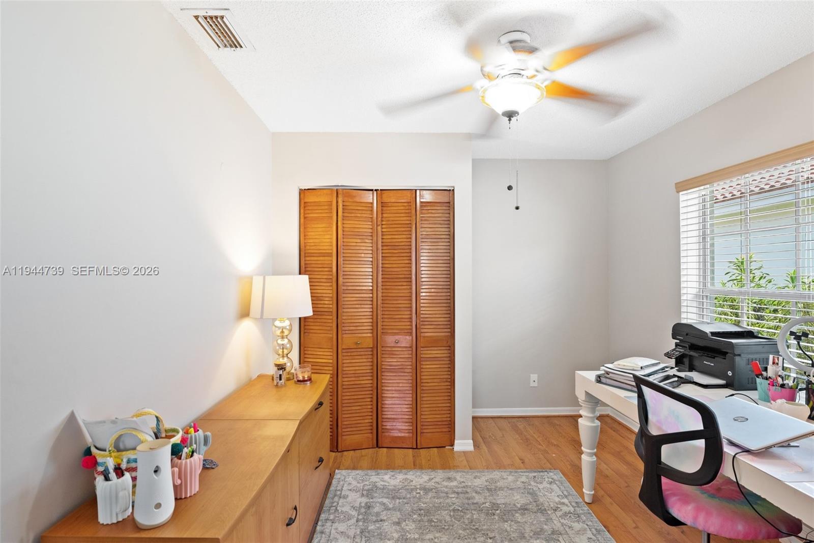 955 Azure Lane Weston, FL 33326 - Photo 16 of 34 a bedroom with a bed and wooden floor