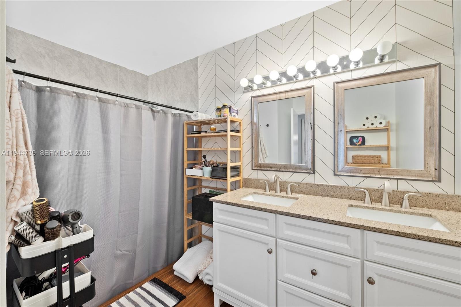 955 Azure Lane Weston, FL 33326 - Photo 20 of 34 a bathroom with a sink double vanity and a mirror