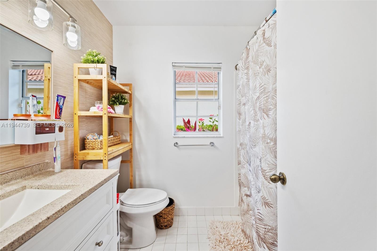 955 Azure Lane Weston, FL 33326 - Photo 25 of 34 a bathroom with a sink toilet vanity and shower