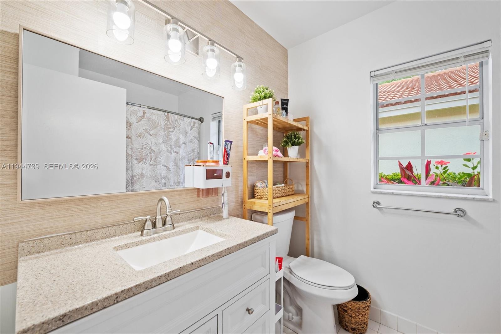 955 Azure Lane Weston, FL 33326 - Photo 26 of 34 a bathroom with a sink vanity mirror and toilet
