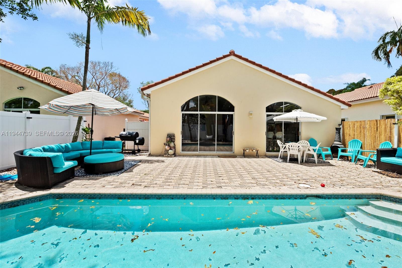 955 Azure Lane Weston, FL 33326 - Photo 27 of 34 a view of a house with backyard and sitting area
