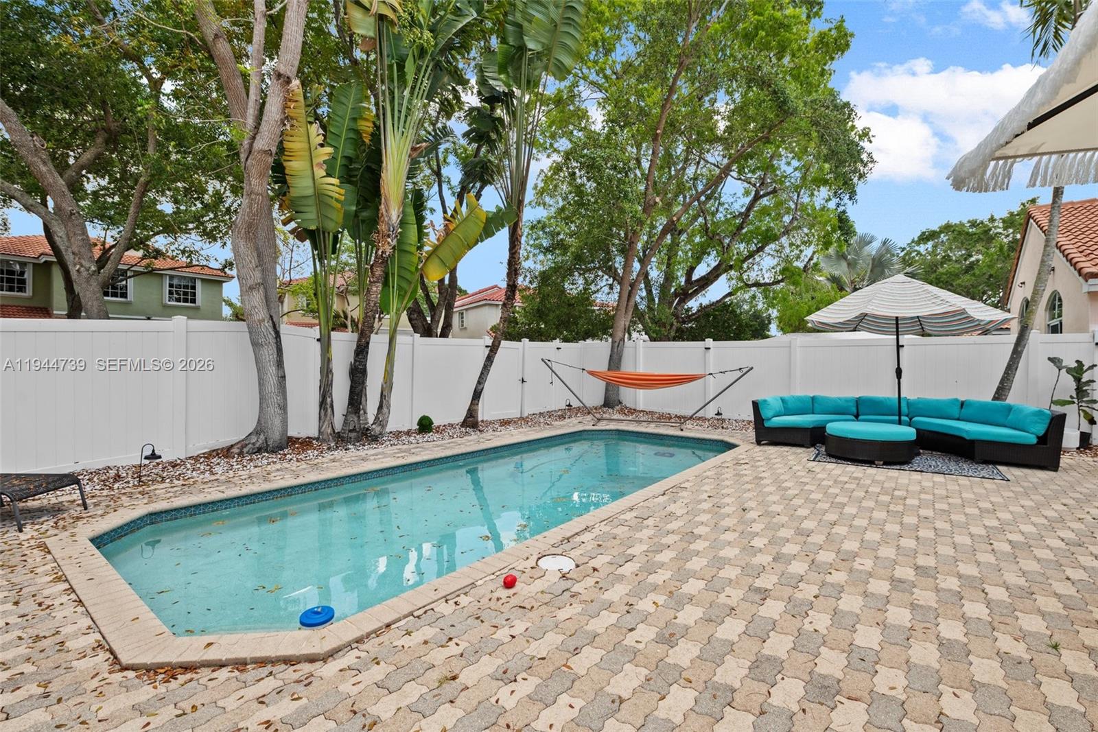 955 Azure Lane Weston, FL 33326 - Photo 29 of 34 swimming pool view with a couple of chairs