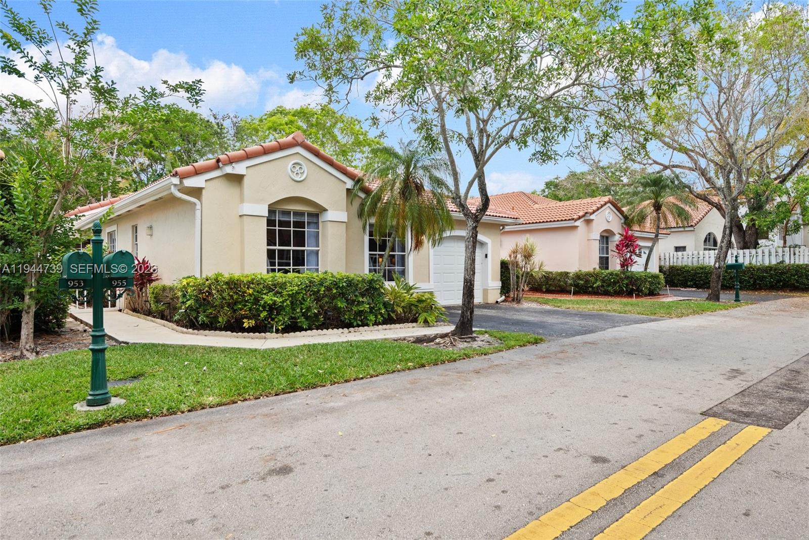 955 Azure Lane Weston, FL 33326 - Photo 3 of 34 a front view of a house with a yard and garage