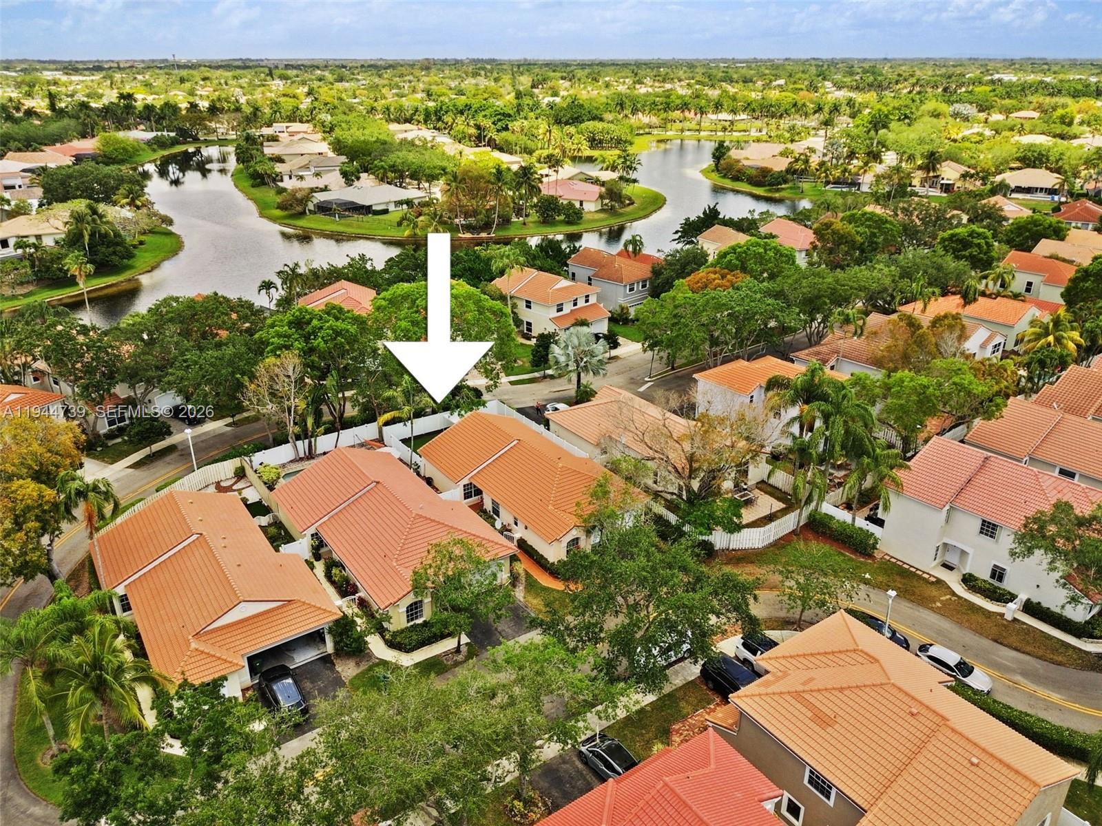 955 Azure Lane Weston, FL 33326 - Photo 34 of 34 an aerial view of a house with a yard and lake view