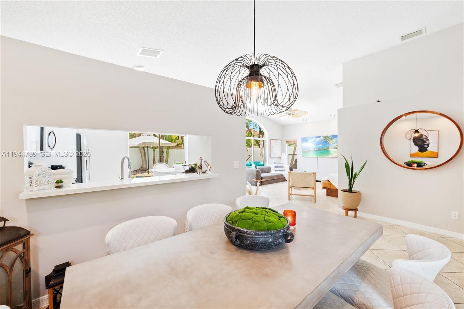 955 Azure Lane Weston, FL 33326 - Photo 9 of 34 a living room with dining table and chairs