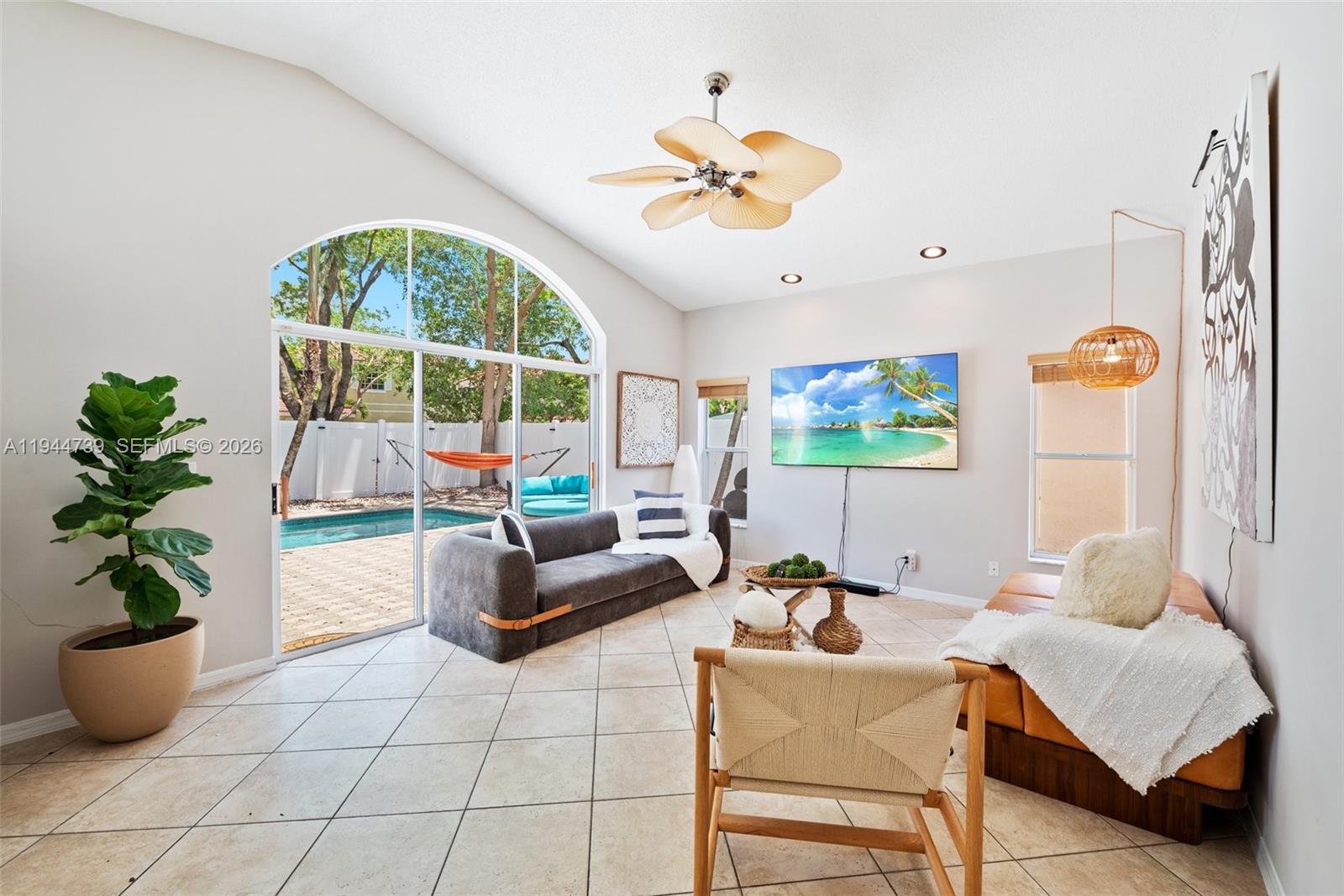 955 Azure Lane Weston, FL 33326 - Photo 10 of 34 a living room with furniture and a potted plant