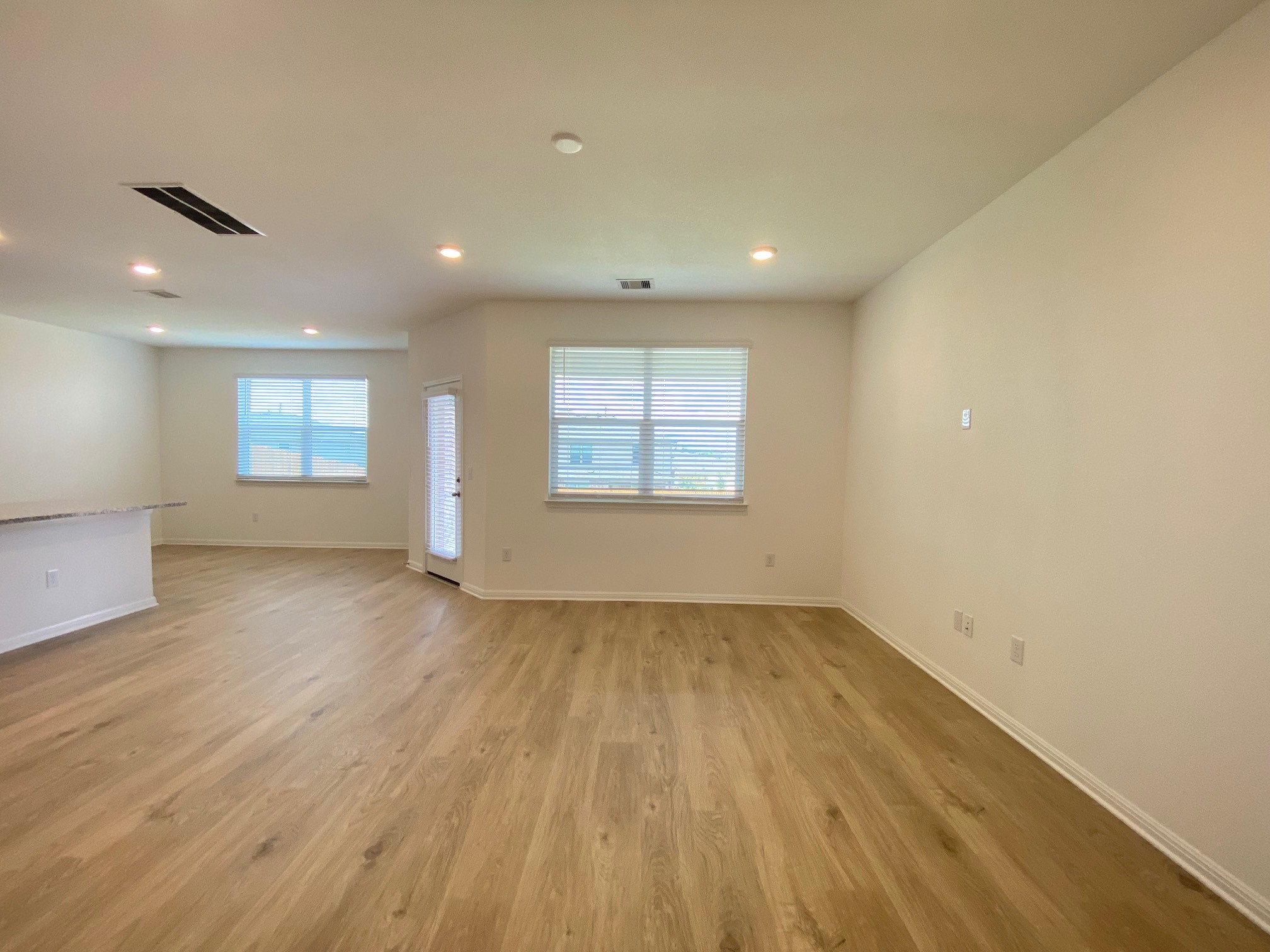 205 Saide Street Georgetown, TX 78626 - Photo 12 of 31 an empty room with wooden floor and windows