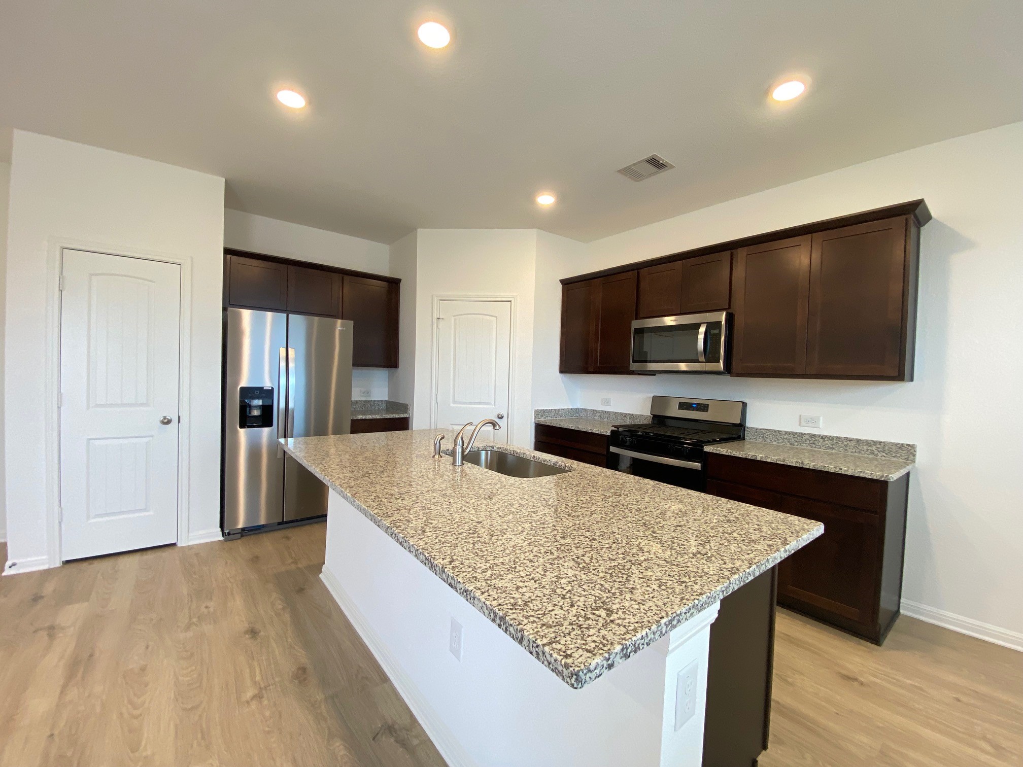 205 Saide Street Georgetown, TX 78626 - Photo 17 of 31 a kitchen with granite countertop counter top space a sink stainless steel appliances and cabinets