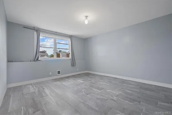 a bedroom with two beds and a dresser