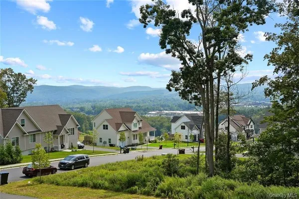 a view of house with garden space and car parked
