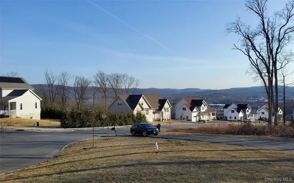 a kitchen with refrigerator and chairs