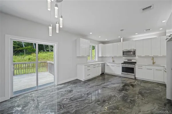 a large kitchen with a table and chairs