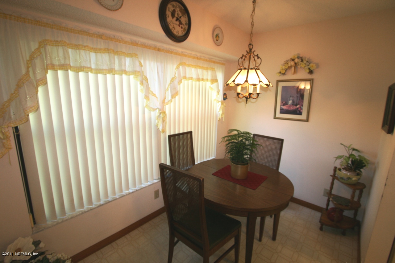 514 Gentian Road St. Augustine, FL 32086 - Photo 12 of 22 a view of a dining room with furniture and a chandelier