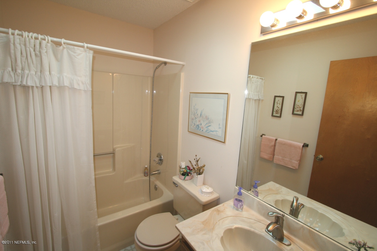 514 Gentian Road St. Augustine, FL 32086 - Photo 17 of 22 a bathroom with a sink a toilet and shower