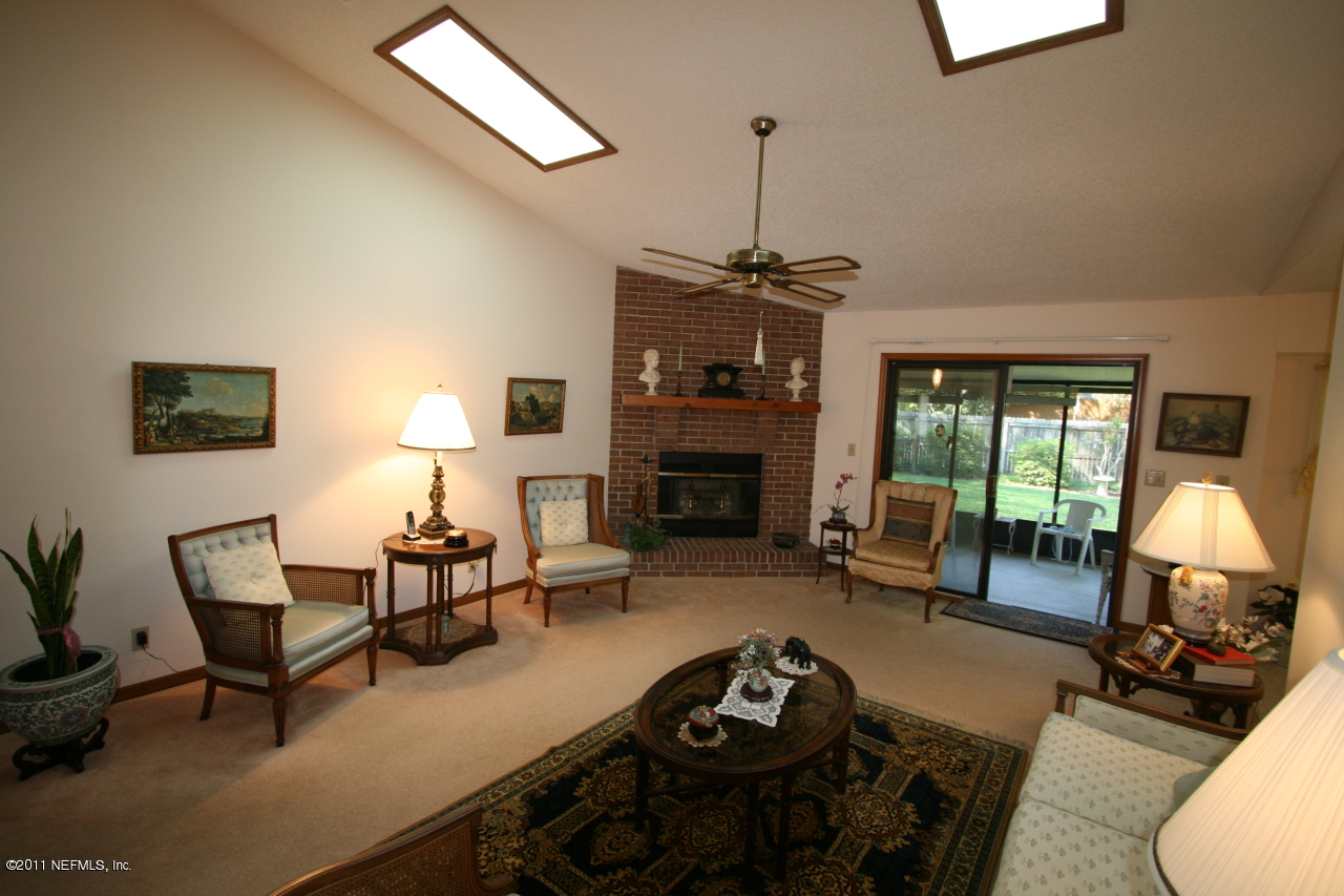 514 Gentian Road St. Augustine, FL 32086 - Photo 7 of 22 a living room with furniture and a fireplace