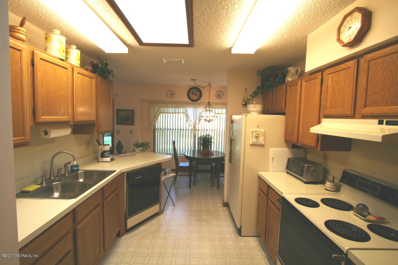 514 Gentian Road St. Augustine, FL 32086 - Photo 10 of 22 a kitchen with a sink stove and refrigerator